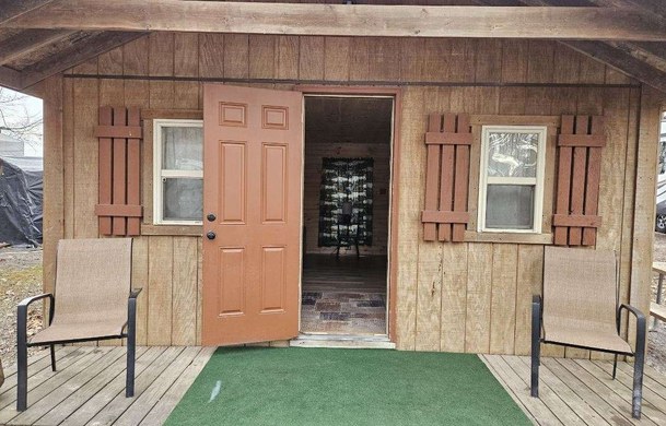 Rustic Cabin exterior with covered porch at Adventure Bound Green Valley