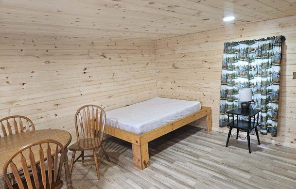 Rustic Cabin interior with regular bed and dining area